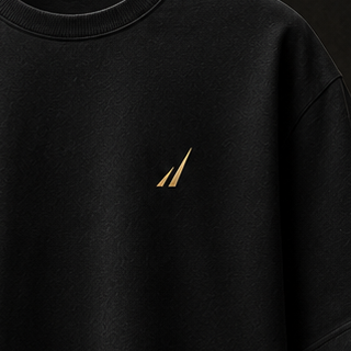 Macro detail of the official THE EDGE symbol embroidered tonally on the left chest of the black Discipline Tee